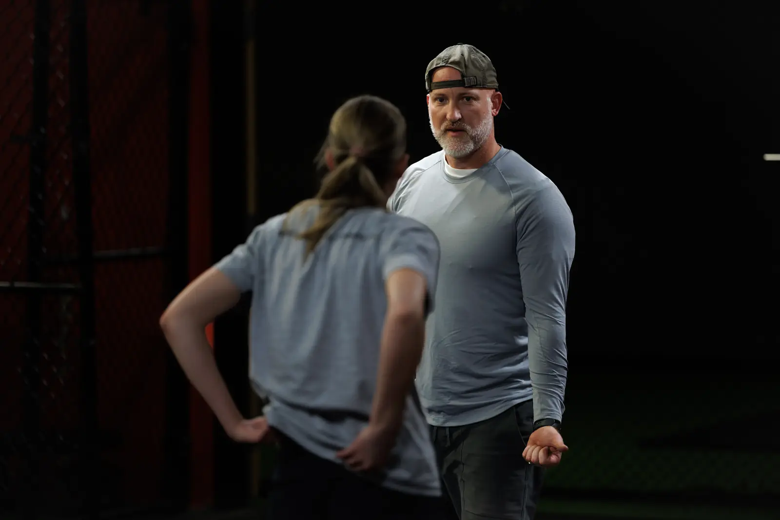 Coach Aaron explaining a movement to an athlete during a session