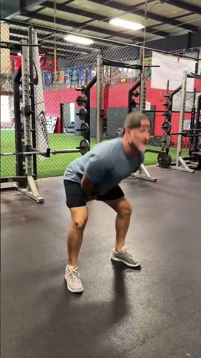 Coach Aaron demonstrating a kettlebell swing in the gym